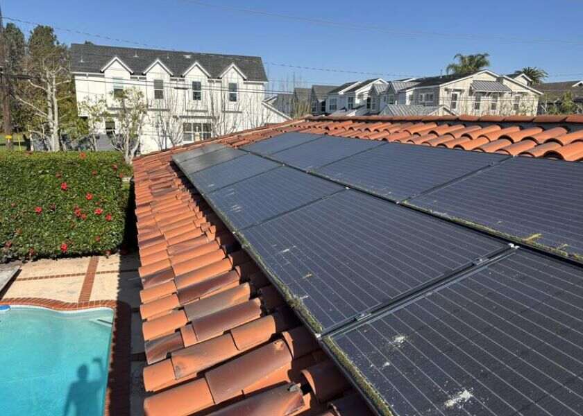A roof with slipped roof tiles with solar panels