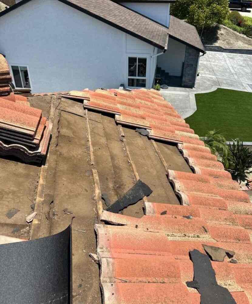 A tiled roof being repaired